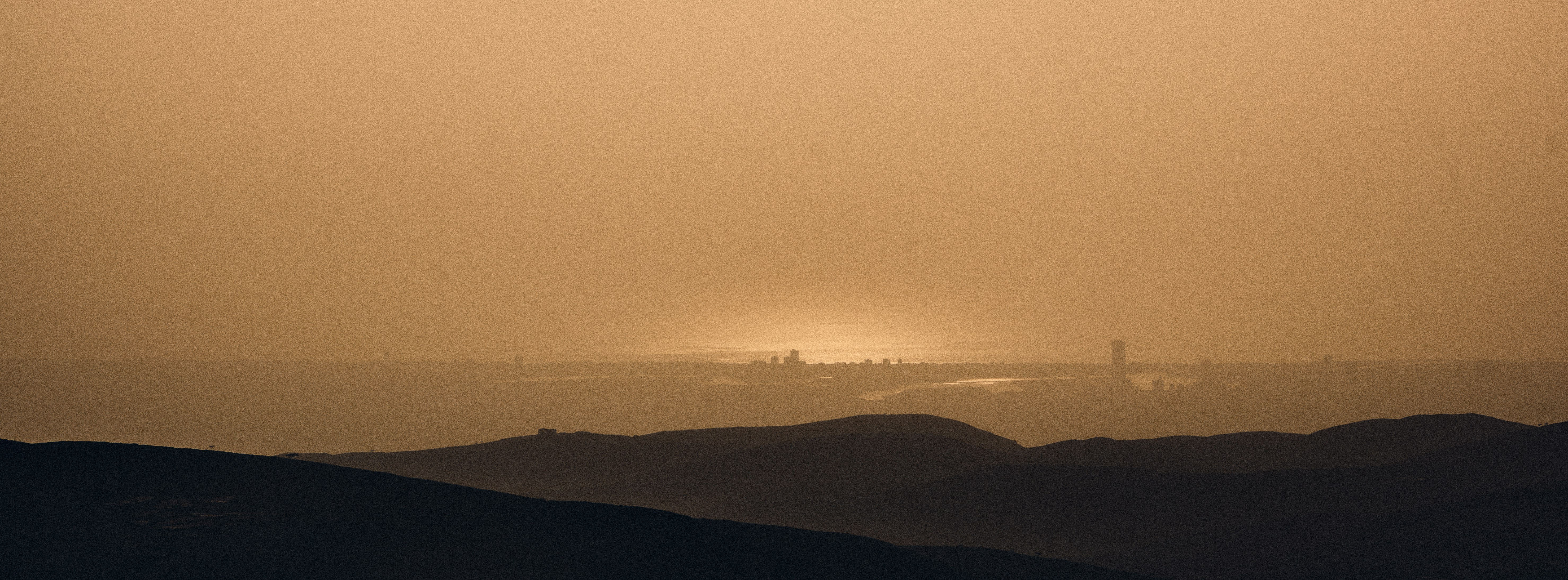 silhouette of mountains during sunset